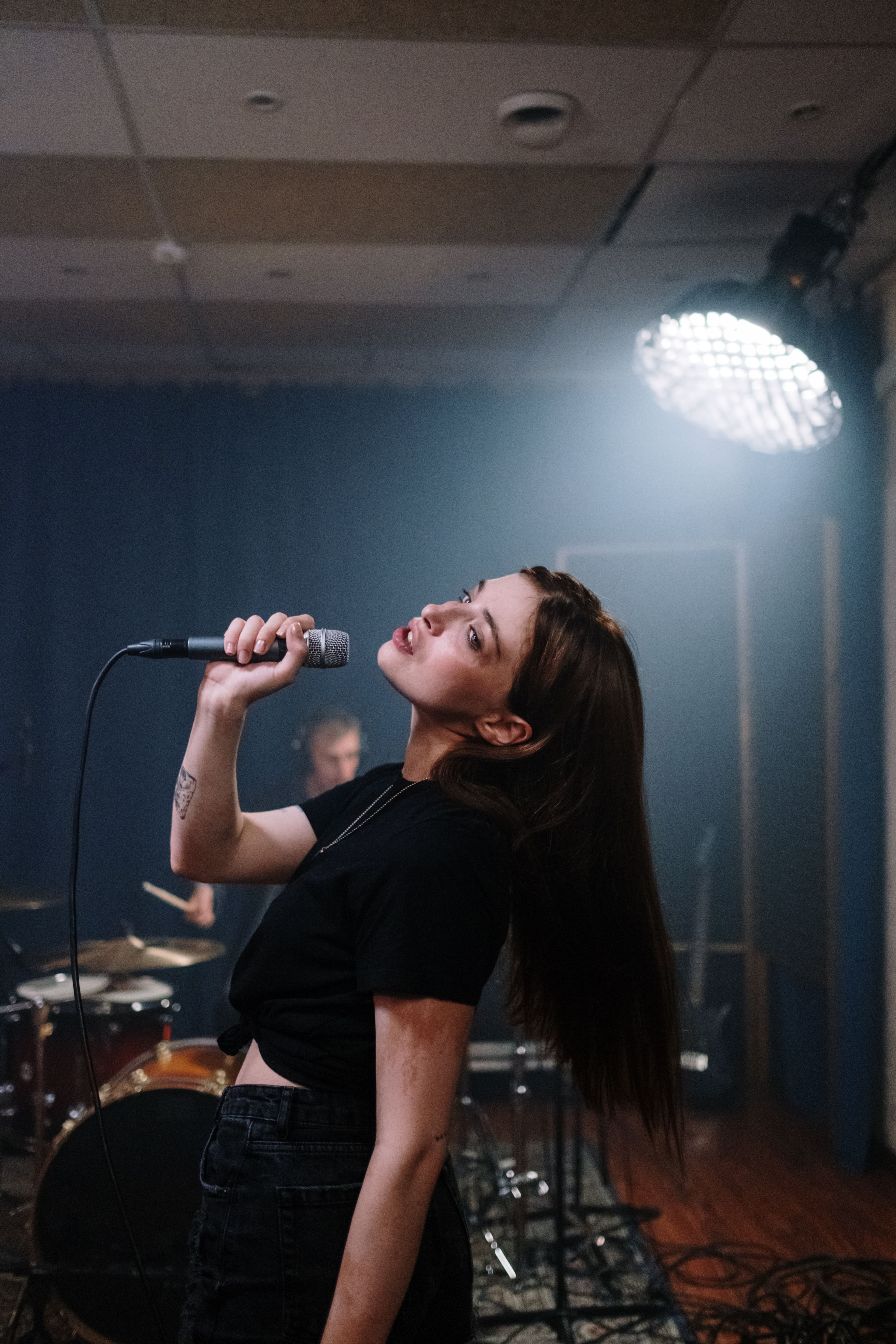 Singer holding a microphone during a performance